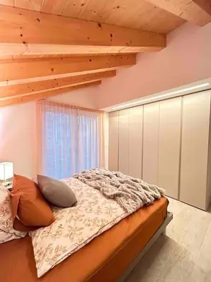 a bedroom with a bed with a wooden ceiling at Agordo Col di Foglia in Agordo