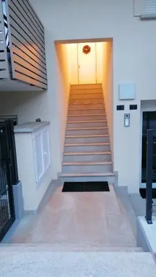 a staircase leading to a door in a building at Agordo Col di Foglia in Agordo