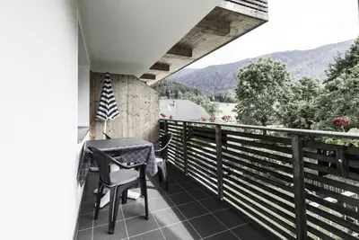 a balcony with a table and chairs and a view at Haus Spielbichl in San Lorenzo di Sebato