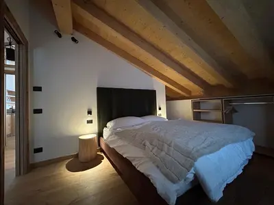 a bedroom with a large bed in a room at Chalet M in Val di Zoldo