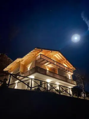 a building with the moon in the sky at Chalet M in Val di Zoldo