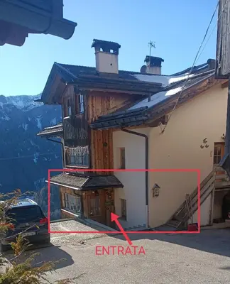 a view of a house with a red arrow pointing to an attic at Appartamento Robert Arabba in Livinallongo del Col di Lana