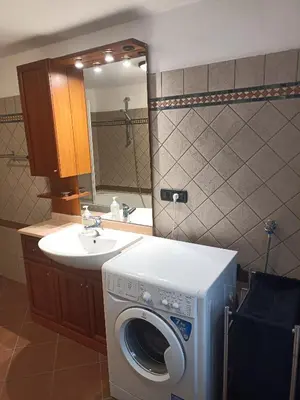 a bathroom with a washing machine and a sink at Appartamento Robert Arabba in Livinallongo del Col di Lana