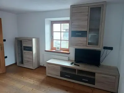 a living room with a dresser and a window at Appartamento Robert Arabba in Livinallongo del Col di Lana