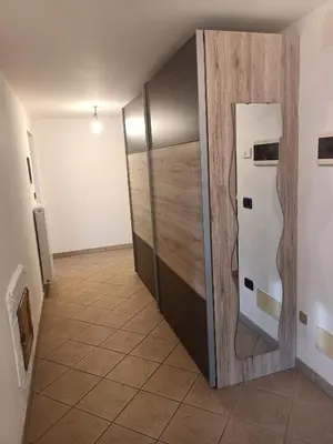 a hallway with a refrigerator in a room at Appartamento Robert Arabba in Livinallongo del Col di Lana