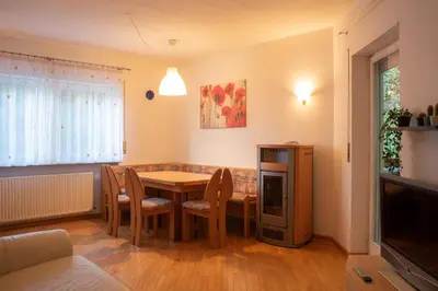 a dining room with a table and chairs and a television at Strategic apartment - near Bolzano in Prato allʼIsarco