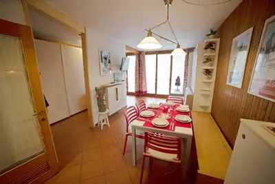 a kitchen with a table with red and white dishes on it at Le Nasse in San Martino di Castrozza
