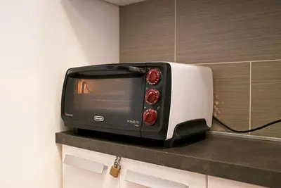 a black and white toaster oven sitting on a counter at Le Nasse in San Martino di Castrozza