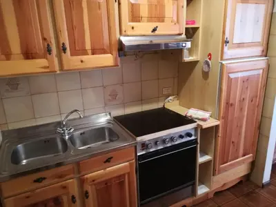 a kitchen with a sink and a stove at Ciasa de Carla in Masarè