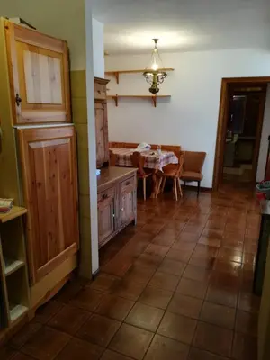 a kitchen with a table and a dining room at Ciasa de Carla in Masarè
