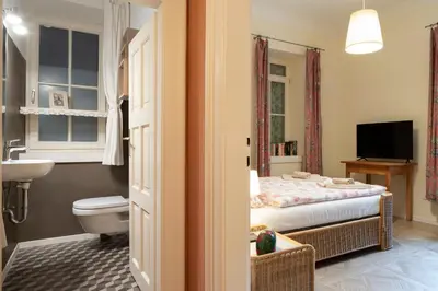 a bathroom with a bed and a toilet and a sink at Appartement Laurin 2 guestcard incl in Merano