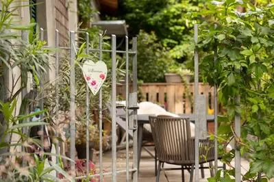 a gate with two chairs and a table in a garden at Appartement Laurin 2 guestcard incl in Merano