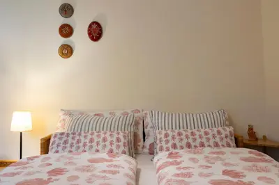a bedroom with two pillows and a bed and a wall at Appartement Laurin 2 guestcard incl in Merano