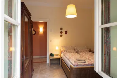 a bedroom with a bed in the corner of a room at Appartement Laurin 2 guestcard incl in Merano
