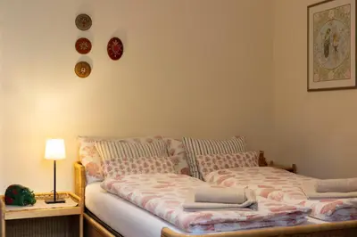 a bedroom with two beds and a table with a lamp at Appartement Laurin 2 guestcard incl in Merano