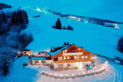 an aerial view of a house in the snow at night at Residenz Erschbaum in Valdaora