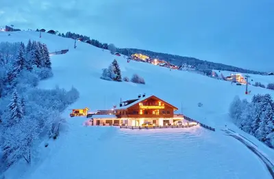a house on top of a snow covered slope at Residenz Erschbaum in Valdaora