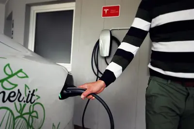 a man fueling a car at a gas station at Residenz Erschbaum in Valdaora
