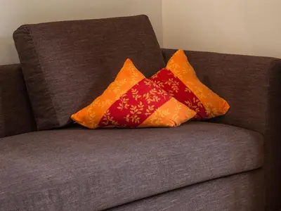 two pillows sitting on top of a couch at Naturhotel Edelweiss in Terento