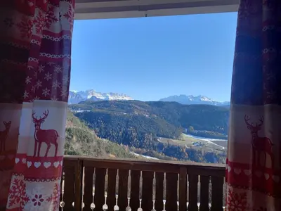 a window with a view of a mountain at Apartment Lärchenheim in Soprabolzano