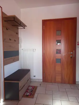 a room with a wooden door next to a staircase at Apartment Lärchenheim in Soprabolzano