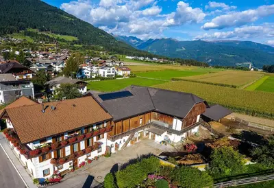 an aerial view of a house and a vineyard at Niedermairhof in Falzes