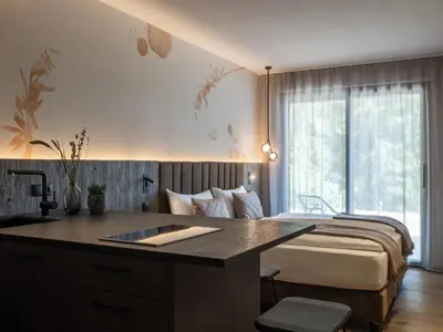 a bedroom with a bed and a desk in it at Arieshof Castell in San Lorenzo di Sebato