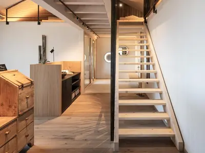 a staircase leading to the kitchen of a loft conversion at Arieshof Castell in San Lorenzo di Sebato