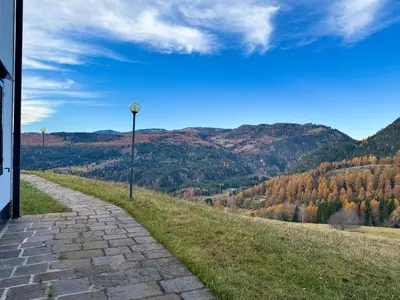 a cobblestone road with a view of a mountain at Family Hut in Carano