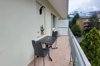 a patio with a table and chairs on a balcony at Casa Grazia - Merano in Merano
