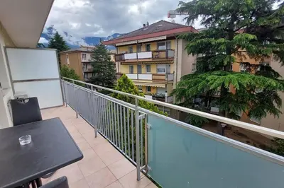a balcony of a building with a table on it at Casa Grazia - Merano in Merano