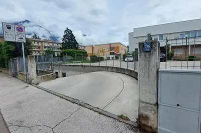 an empty street with a fence and a road at Casa Grazia - Merano in Merano