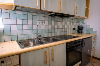 a kitchen with a sink and a stove at Sun & Mountains Cavalese in Cavalese