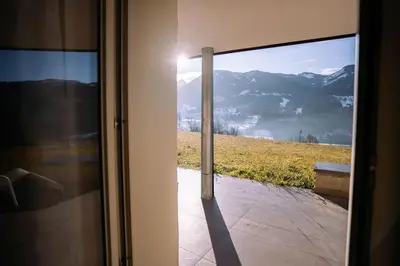 a door with a view of a mountain view at Sun & Mountains Cavalese in Cavalese
