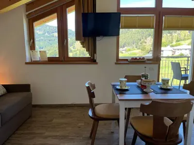 a living room with a table and a couch at Respira il Bosco in Anterivo