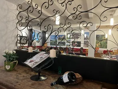 a table with a bottle of wine and a mirror at Respira il Bosco in Anterivo