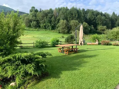 a picnic table in the middle of a field at CASA BRUNELLA in Cavalese