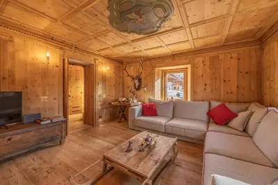 a living room with a couch and a table at Casa Alvera Dream in Cortina dʼAmpezzo