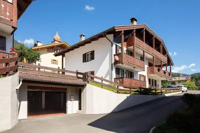 a large white building with balconies on top of it at Casa Lucia Moena in Moena