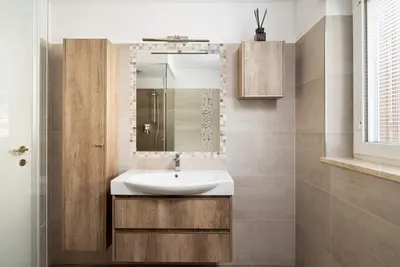 a bathroom with a sink and a mirror at Casa Lucia Moena in Moena