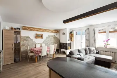 a living room with a couch and a table at Casa Lucia Moena in Moena