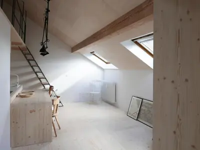 a loft conversion with a skylight and white walls at House Design Vipiteno in Vipiteno