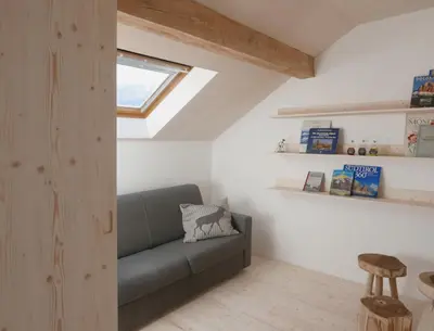 a living room with a couch and a window at House Design Vipiteno in Vipiteno