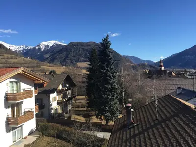 a person standing on the roof of a house at House Design Vipiteno in Vipiteno