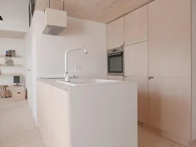 a kitchen with white cabinets and a sink at House Design Vipiteno in Vipiteno