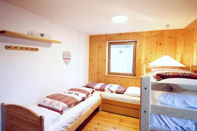 a green background with the words bangalore nor indialinear not included at CASA DOLOMIA - 3 camere, 2 bagni, parcheggio Dolomiti Affitti in Cavalese