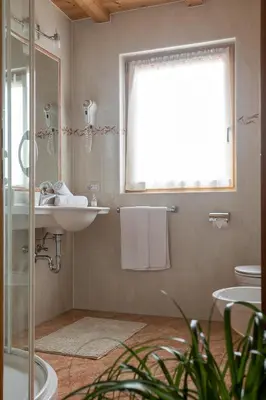a bathroom with a sink and a mirror at Apartments Etruska Gabriela in Santa Cristina in Val Gardena