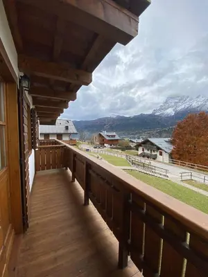 a wooden balcony with a view of a mountain at Chalet Panorama Dolomiti vicino piste, centro e Cortina in San Vito di Cadore