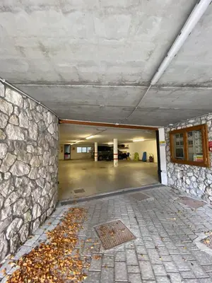 an empty parking garage with a stone wall at Chalet Panorama Dolomiti vicino piste, centro e Cortina in San Vito di Cadore