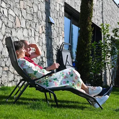 a man and woman sitting in a lawn chair at Pitzoler Hof in Albes